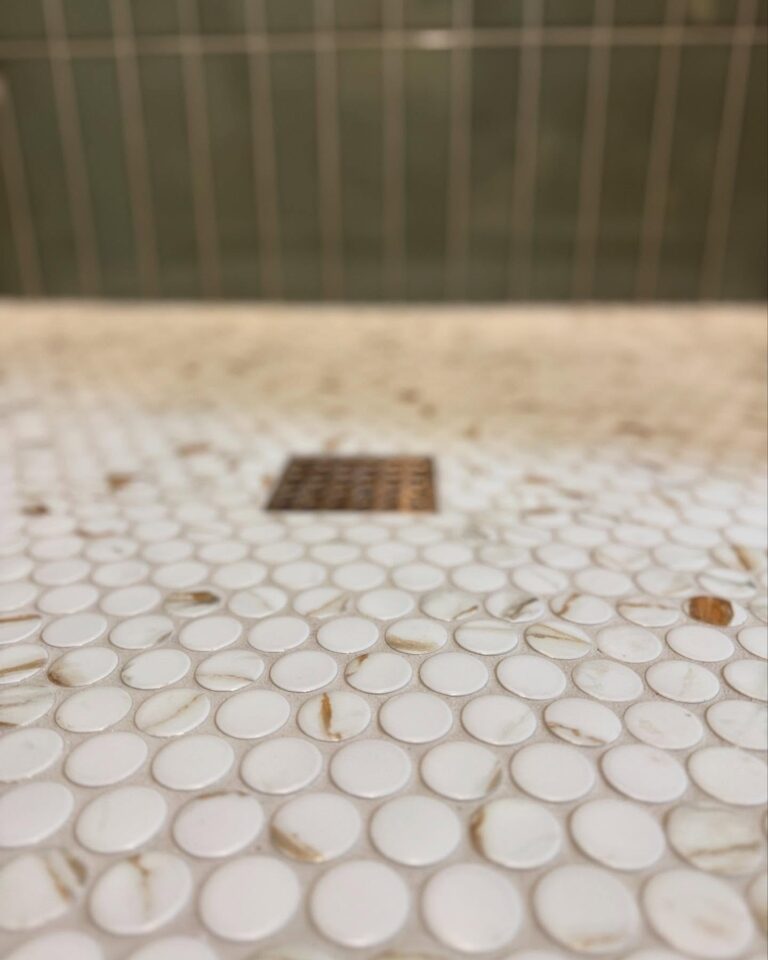 Close-up view of penny tiles and new professionally installed drain
