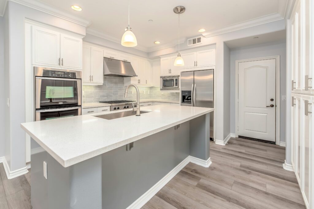 Central island of a kitchen surrounded by modern applianced